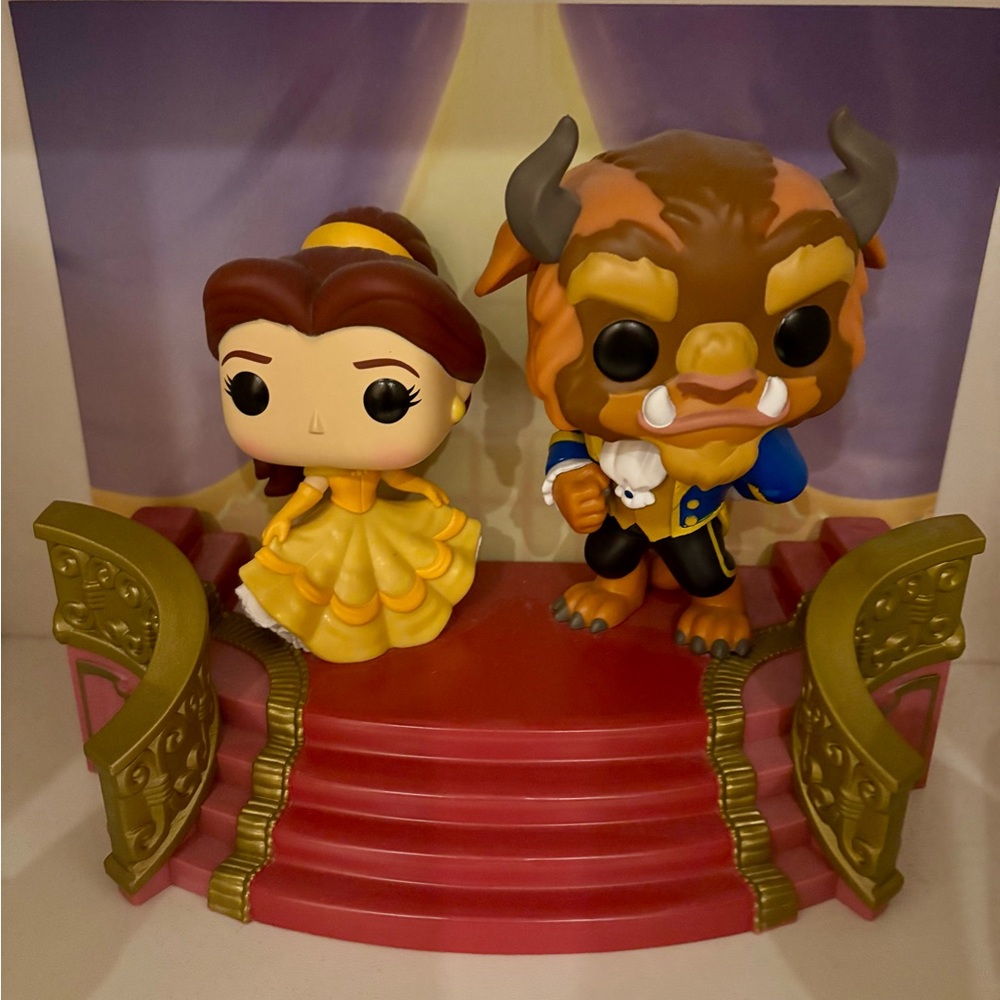 Funko Belle and Beast Figures on Red and Gold Stage